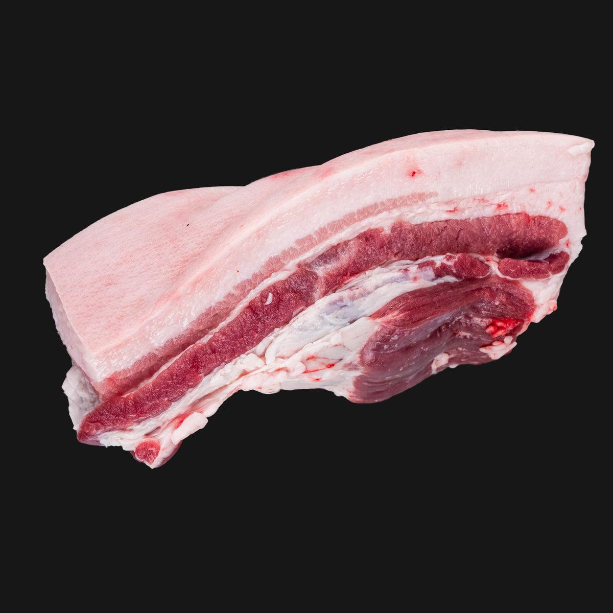 Raw pork belly on a black background